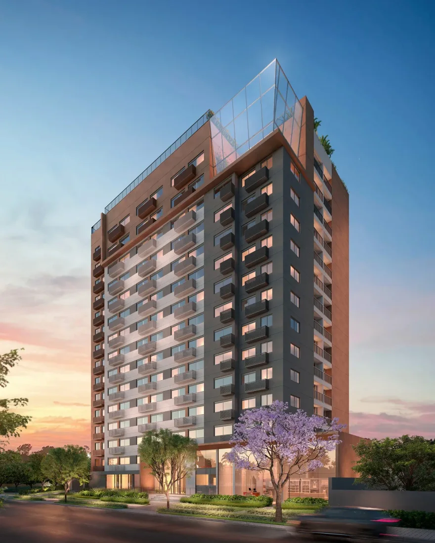 Torre residencial de alto padrão ao entardecer, com fachada de esquadrias de alumínio e vidro